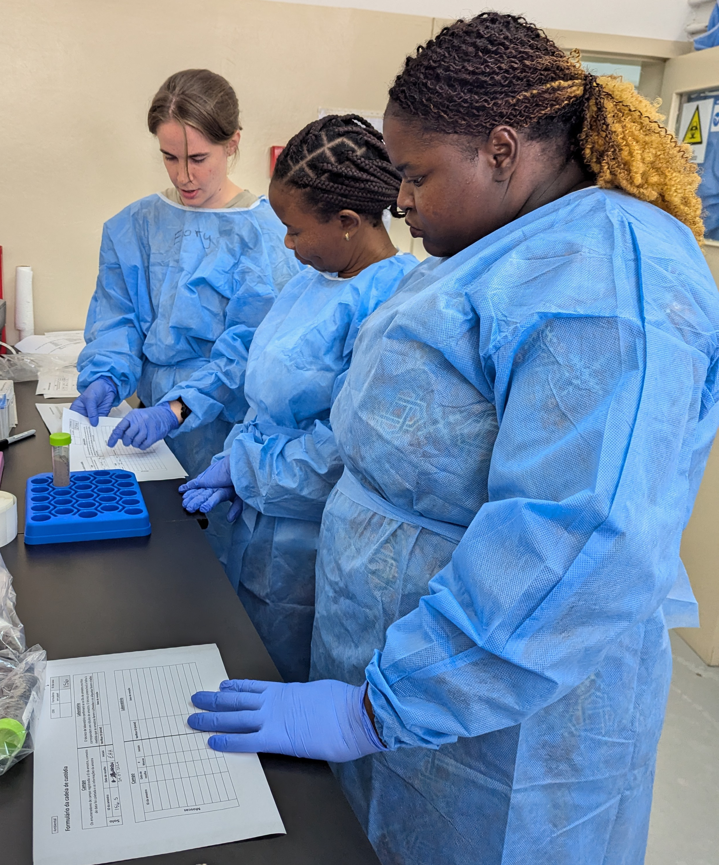 Master's student Emory Hoelscher-Hull helping to train lab staff in Quelimane this summer